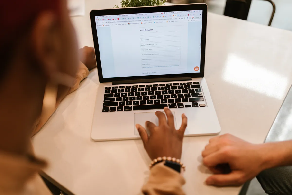 A job seeker filling in an application form on a laptop