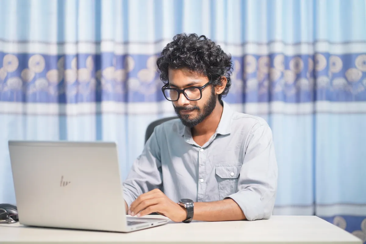 An Indian job seeker comparing two auto-apply tools on a laptop