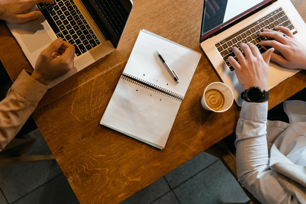 Comparing Naukri and LinkedIn for a job search in India on two laptops