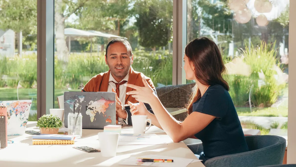 Two professionals discussing a notice period in an office